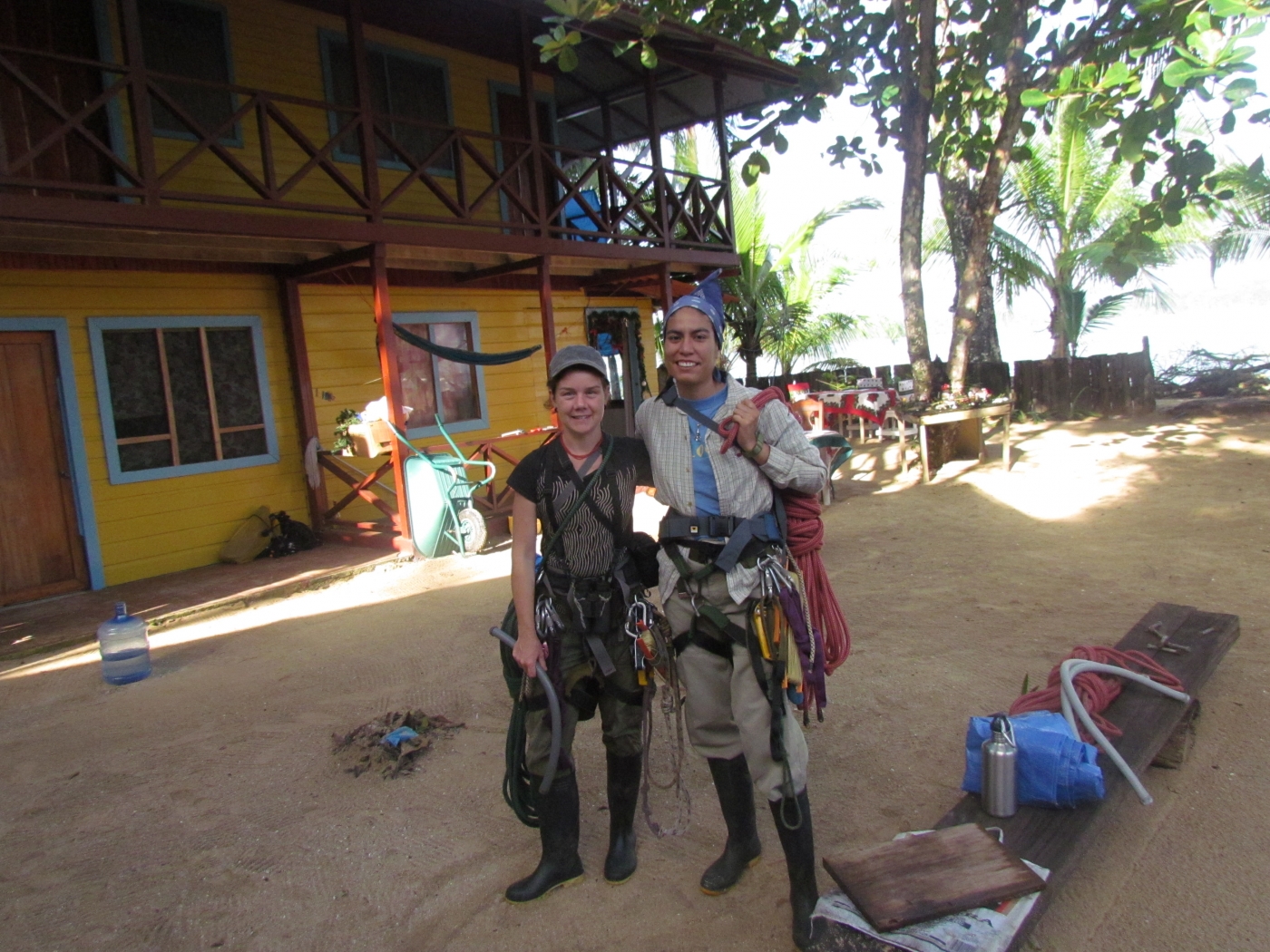 Conservation biologists Tremaine Gregory and Farah Carrasco Rueda pose for a photo wearing climbing gear while attending a tree-climbing course in Panama.