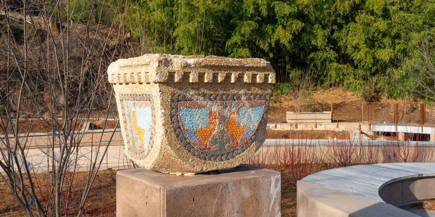 A close-up shot of a colorful tile as seen on the top part of a column, mounted on display in the garden outside the Bird House. The rest of the column has long since been removed.