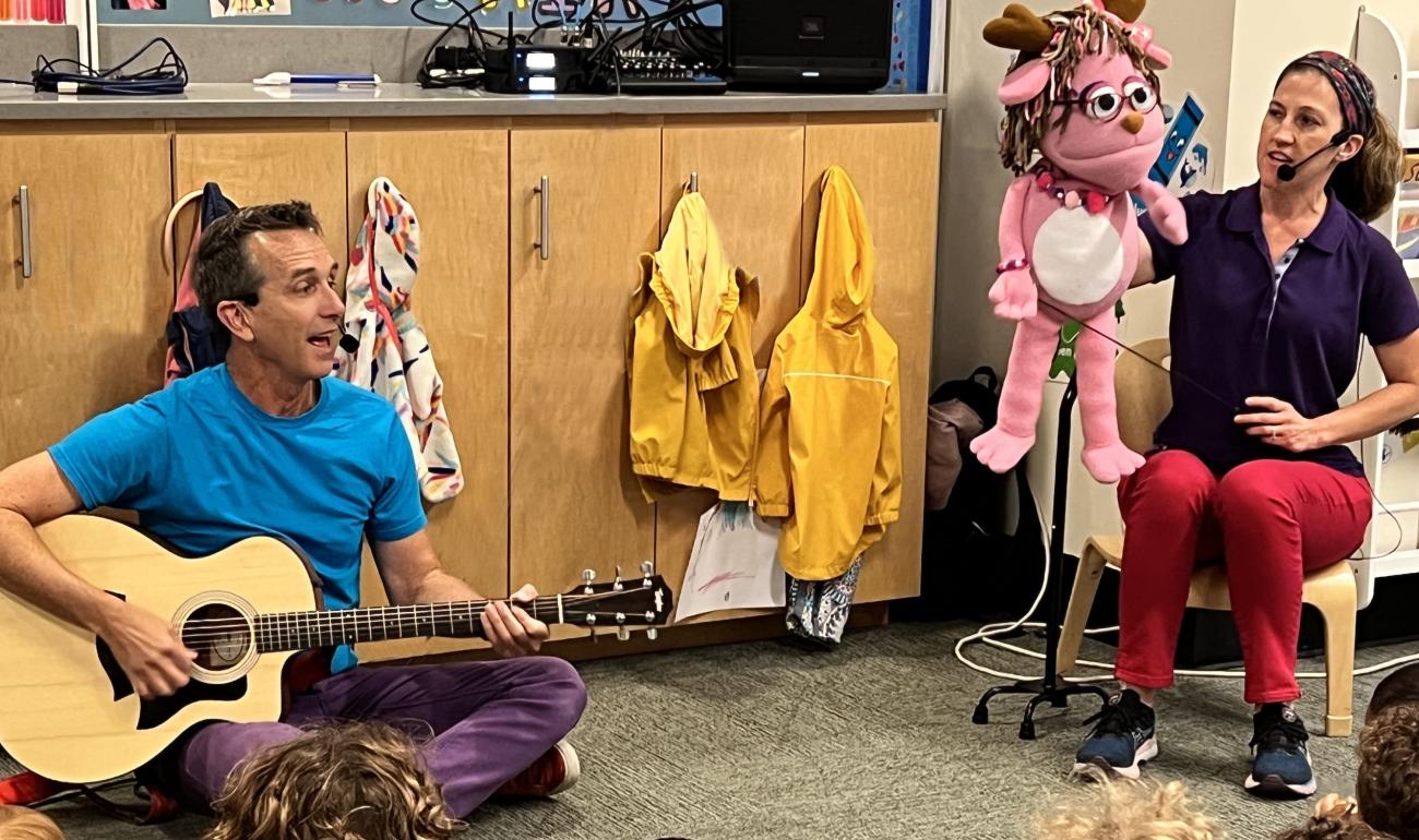 Nick Young (Nick the Music Man) and Rachel Hutchison (puppeteer for Pinky Jackalope) lead children in an early childhood concert