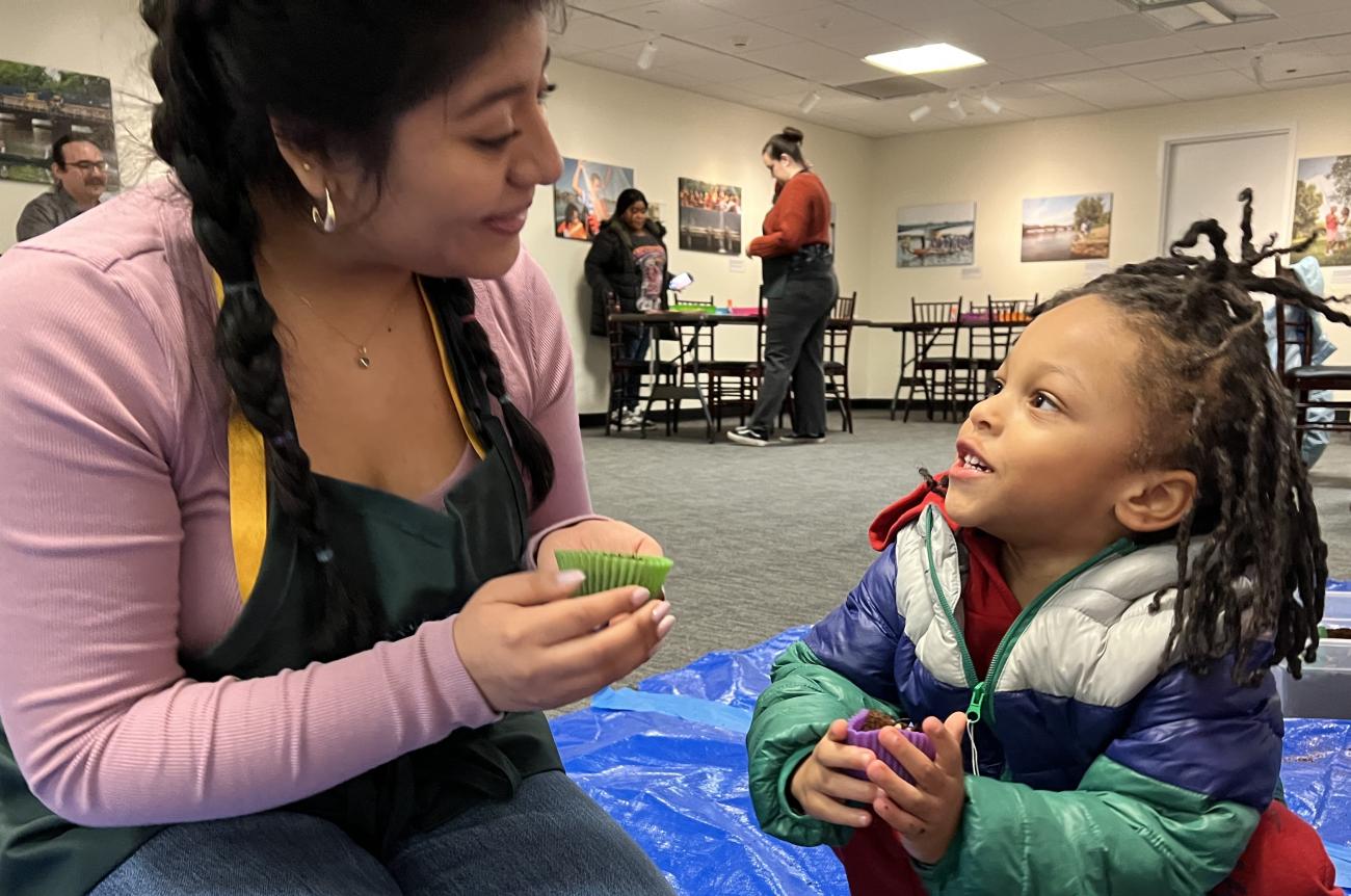 Early childhood facilitator has conversation with young child