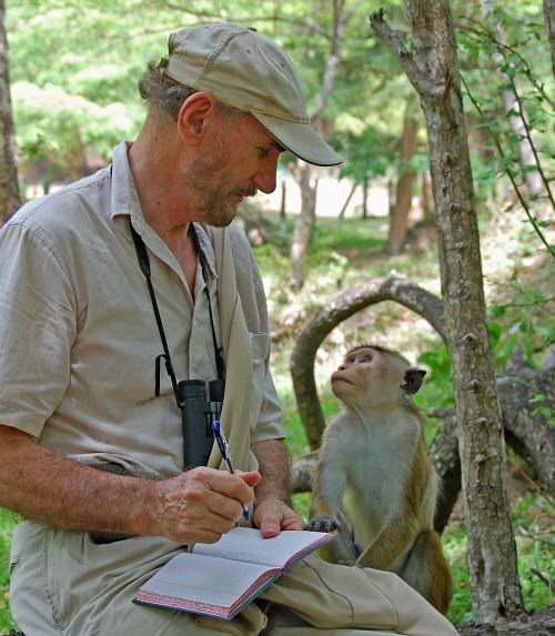 Wolf Dittus with a curious macaque