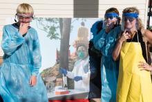 Students posing wearing protective clothing wildlife scientists studying zoonotic diseases wear in the field. 