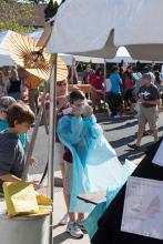 Students at Conservation Discovery Day wearing protective clothing scientists use in the field and playing games. 