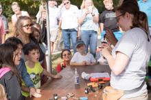 A bird-banding demonstration by Smithsonian Migratory Bird Center Scientists at Conservation Discovery Day. 