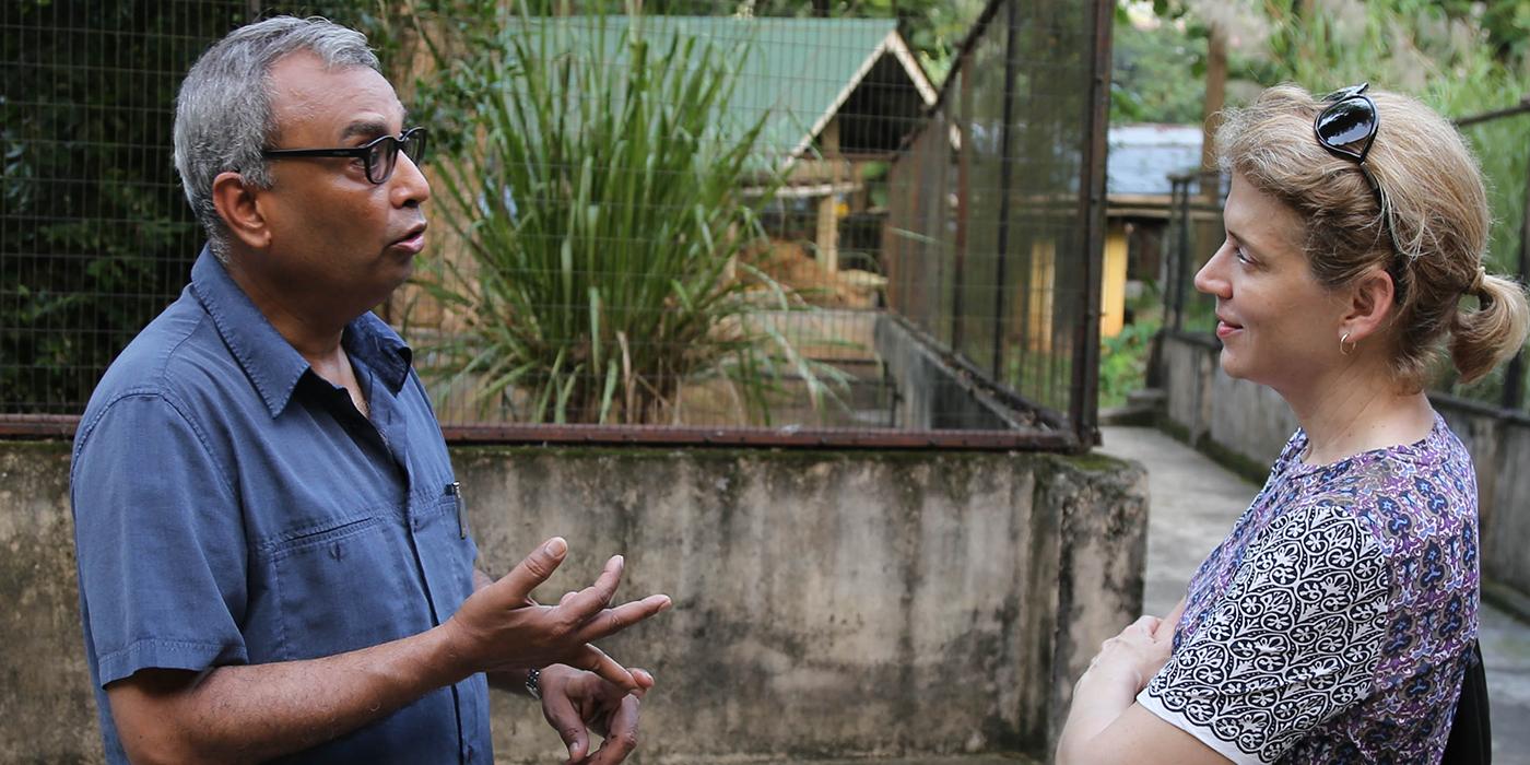 Smith talks with a colleague in India