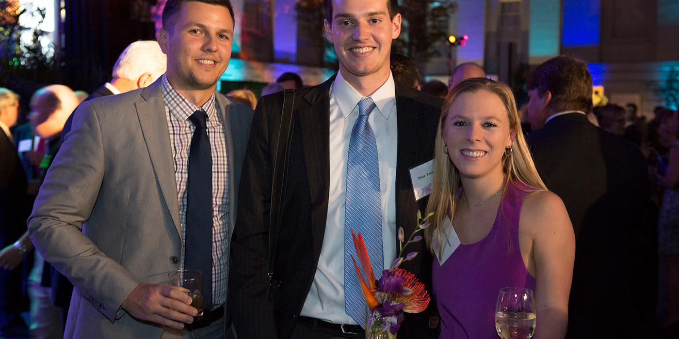 Two men and a woman pose for a photo at the Smithsonian's National Zoo's Monkey Business Gala