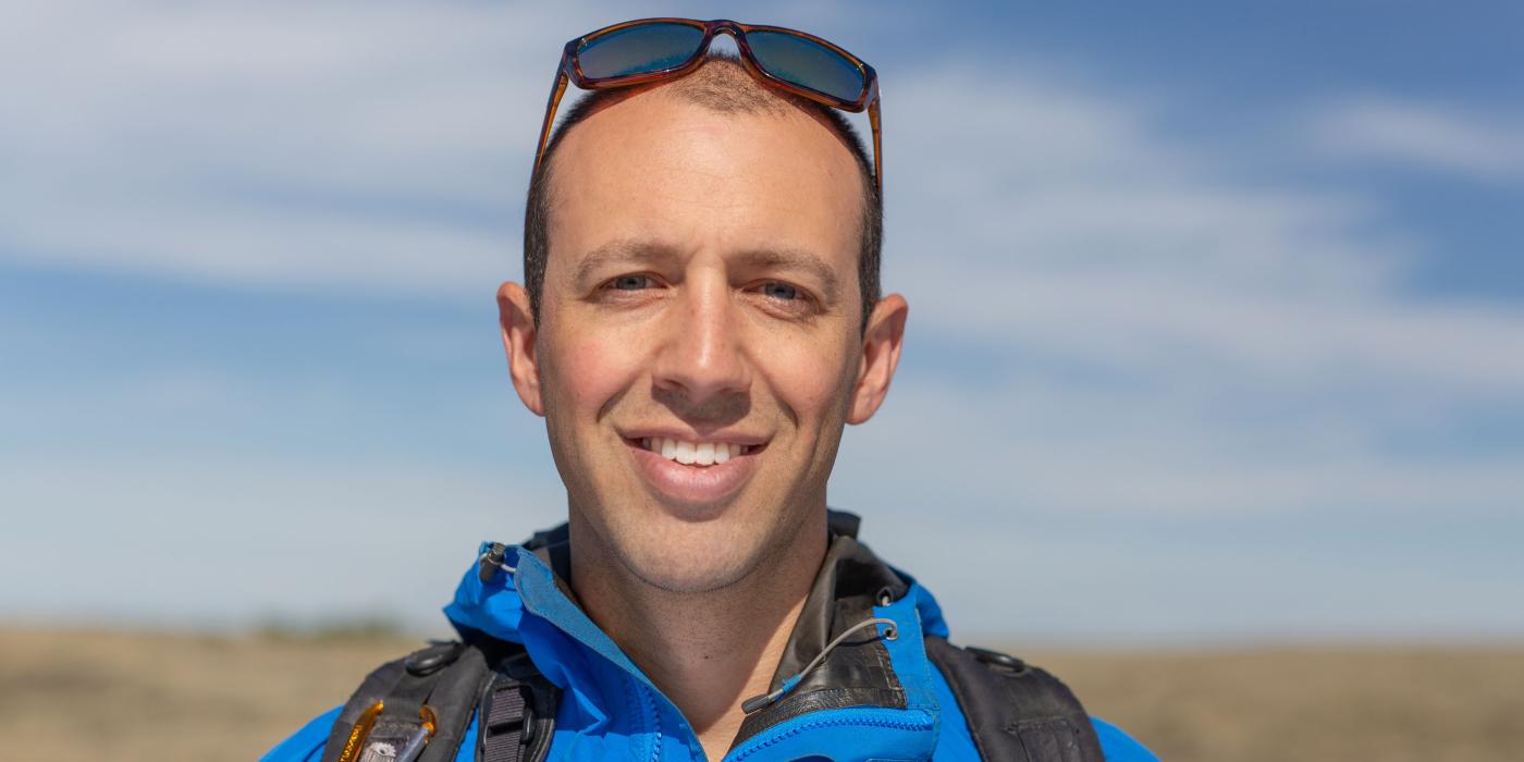 A head shot of ecologist Andy Boyce in the field at the American Prairie Reserve in Montana