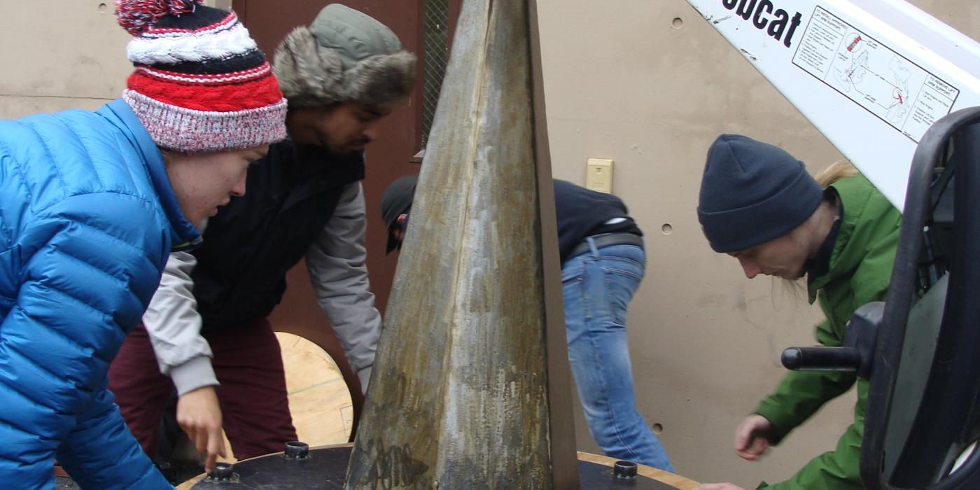 MICA students deliver an enrichment item to the Zoo's elephants